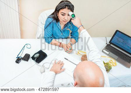 Male Doctor Taking Temperature With Gun To Patient. Doctor Measuring Temperature With Infrared Gun T