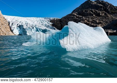 Chunk Of Glacier Ice Lit By Rising Sun Folgefonna Glacier Mosevatnet Lake, Norway