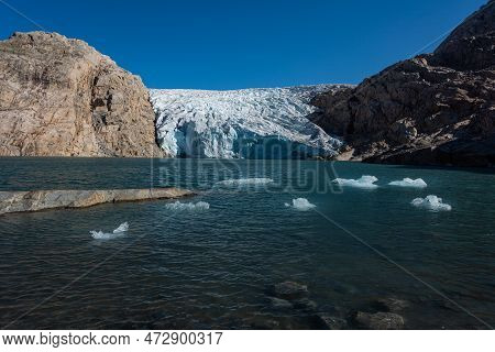 Chunks Of Glacier Ice Lit By Rising Sun Folgefonna Glacier Mosevatnet Lake, Norway