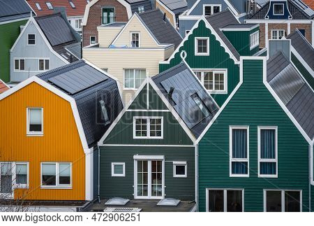 Picturesque Dutch Houses With Wooden Facades, Rooftops Of Modern Dutch Homes With Solar Panels