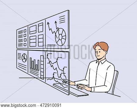 Man Working On Numerous Computer Monitors With Financial Graphs And Diagrams. Male Employee Busy Wit