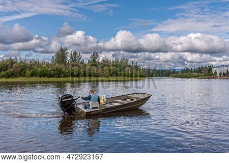 Fairbanks, Alaska, Usa - July 27, 2011: Chena River. Fisherman Alone In Small Mercury Motor Boat Nam
