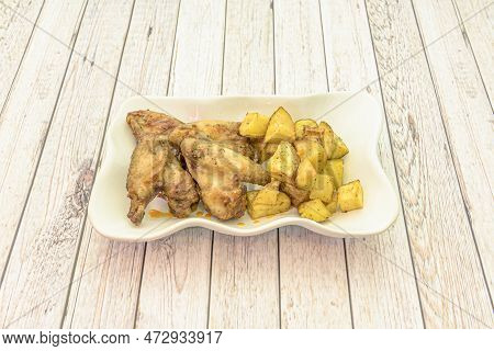 Tapa Of Garlic Chicken Wings In The Purest Spanish Style Served With French Fries In A Deep Plate