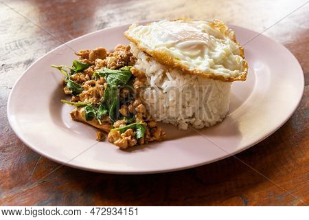 Serving Of Prad Ka Pao, Popular Thai Steet Food Made Up Of Fried Minced Pork With Basil And Fried Eg