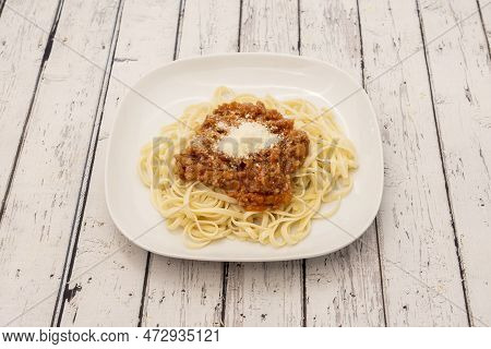 Cooked Wheat Flour Pasta Noodles Accompanied By The Everlasting Italian Bolognese Sauce On A White P
