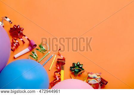 Flat Lay Composition With Accessories For Birthday Party On Orange Background. Space For Text