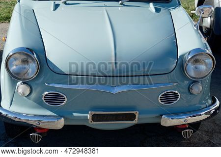 Front View Of An Old German Classic Car . Particular View Of Front Lights And Shiny Chrome Bumper . 