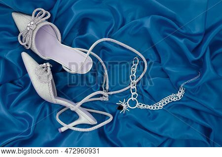High Heel Shoes  On A Blue Background