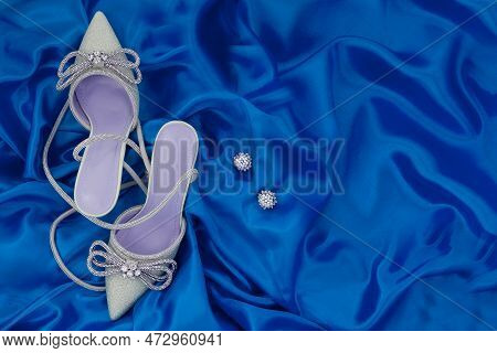 High Heel Shoes  On A Blue Background