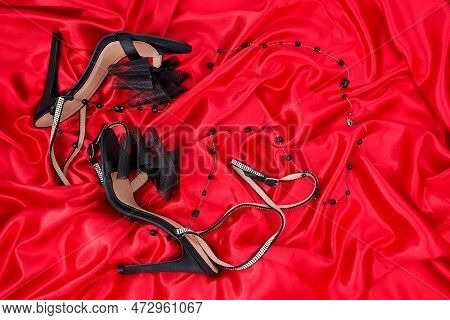 High Heel Shoes  On A Red Background