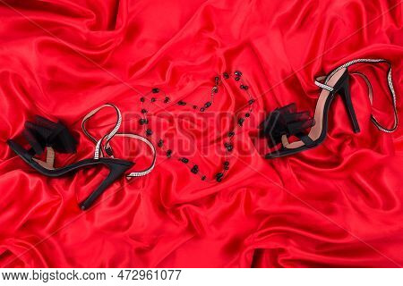 High Heel Shoes  On A Red Background