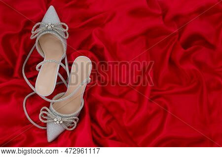 High Heel Shoes  On A Red Background