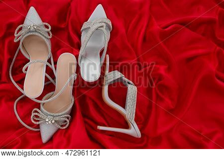 High Heel Shoes  On A Red Background