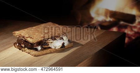 Less Than Perfect S'more That Is Freshly Homemade Next To A Campfire With Copy Space Above