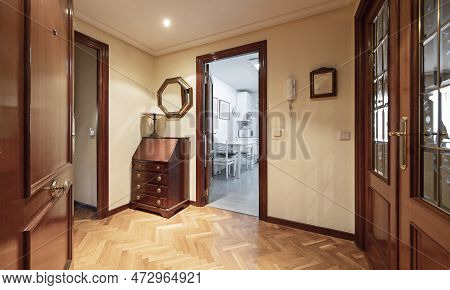Hall Of A House With Armored Door, Wooden Sideboard And Mirror With Wooden Frame And Doors With Sape