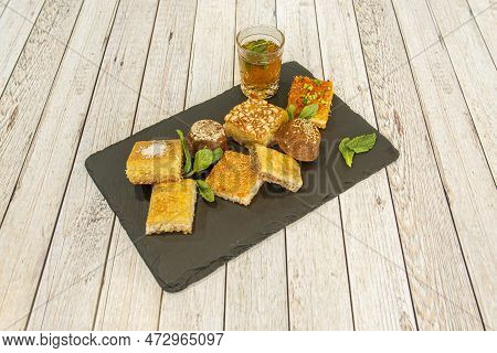 Baklava Cakes With Sesame, Coconut, Pistachio And Coconut Zest, All Garnished With Peppermint Leaves