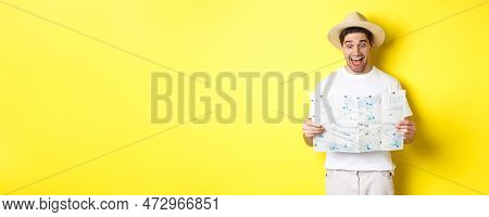 Travelling, Vacation And Tourism Concept. Man Tourist Looking Happy At Map With Sighsteeings, Explor