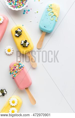 Homemade Sweet Cakesicles Decorated For Spring On A White Table.