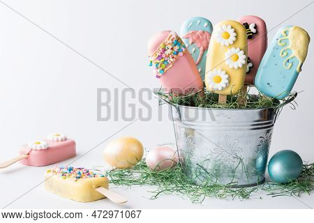 A Tin Pail Filled With Homemade Cakesicles For Easter. Copy Space To The Left.