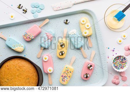 A Sheet Pan Topped With Homemade Cakesicles Decorated For Springtime.