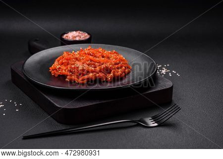 Dried Squid Chopped Into Slices And Seasoned With Sesame Seeds And Spices
