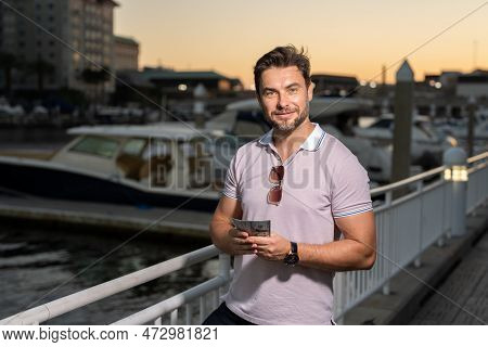 Portrait Of Handsome Confident Stylish Man In Big City. Sexy Man In Casual Clothes Posing On The Str