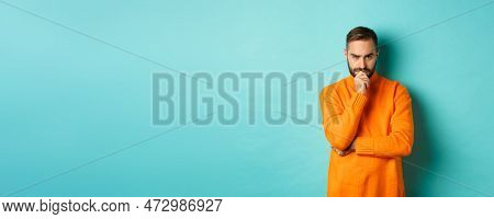 Thougtful Young Man Making Decision, Looking Serious And Thinking, Choosing, Standing Near Copy Spac