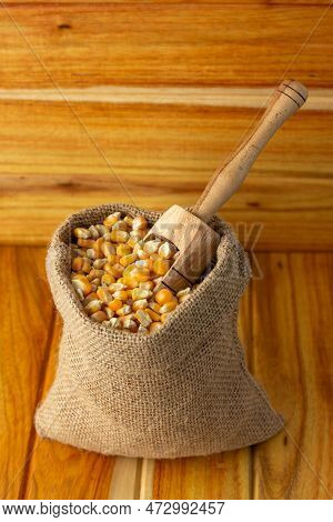 Corn Kernels - Handful Of Corn Kernels With Wooden Spoon