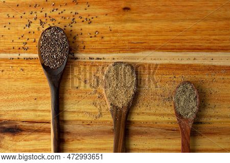 Guayacan Wood Background And Wooden Spoons With Condiments