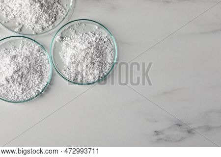 Petri Dishes With Calcium Carbonate Powder On White Marble Table, Flat Lay. Space For Text