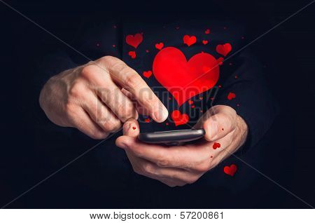 Man Typing Love Text Messages On A Smartphone For Valentine's Day