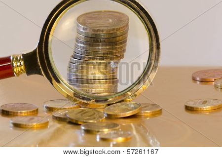 A Stack Of Coins Under A Magnifying Glass