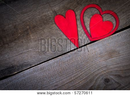 Red hearts on old wood with copy space.