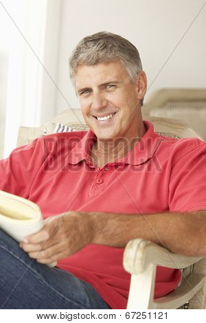 Mid age man reading a book