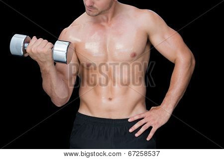 Strong crossfitter lifting up heavy dumbbell on black background