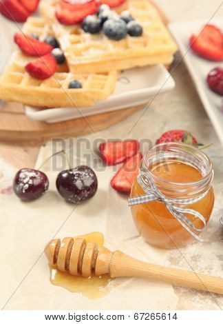 Sweet waffles with honey and berries