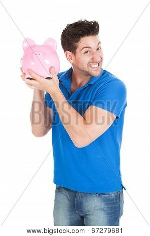 Young Man Holding Piggybank