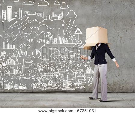 Businesswoman using mobile phone wearing carton box on head