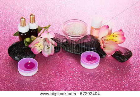 Candles and aroma oil, salt, stones, flower