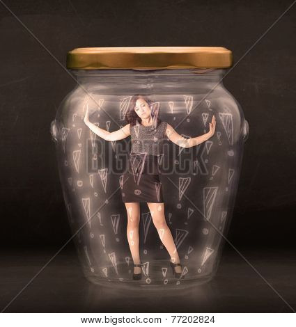 Business woman trapped in jar with exclamation marks concept on bakcground