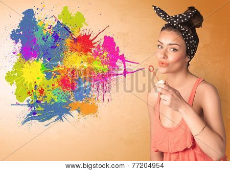 Cute girl blowing bubble spalsh graffiti into wall