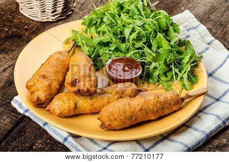 Corn Dog With Fresh Arugula Salad And Hot Dip