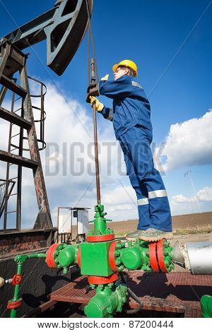Worker on the oil field. Refinery, oil and gas