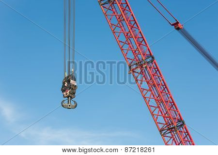 Red Crane Boom With Hook Against Blu Sky