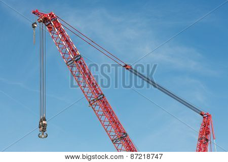 Red Crane Boom With Hook Against Blu Sky