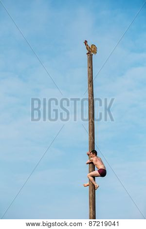 GOMEL, BELARUS - February 21, 2014 Young man climbs on a wooden