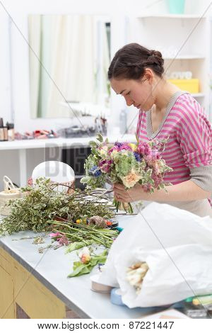 Masterclass Of Smiling Florist At Work With Bunch Of Flowers