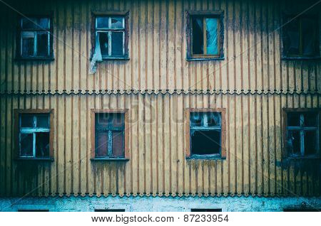 Smashed Glass Window With Old Wooden Frame On Grunge Wall Damaged House
