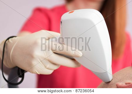 man receiving laser epilation at armpit on beauty center