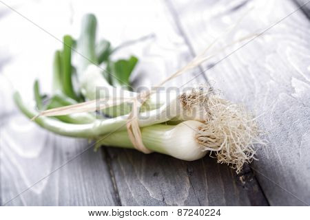 Leeks on wooden table - close-up
